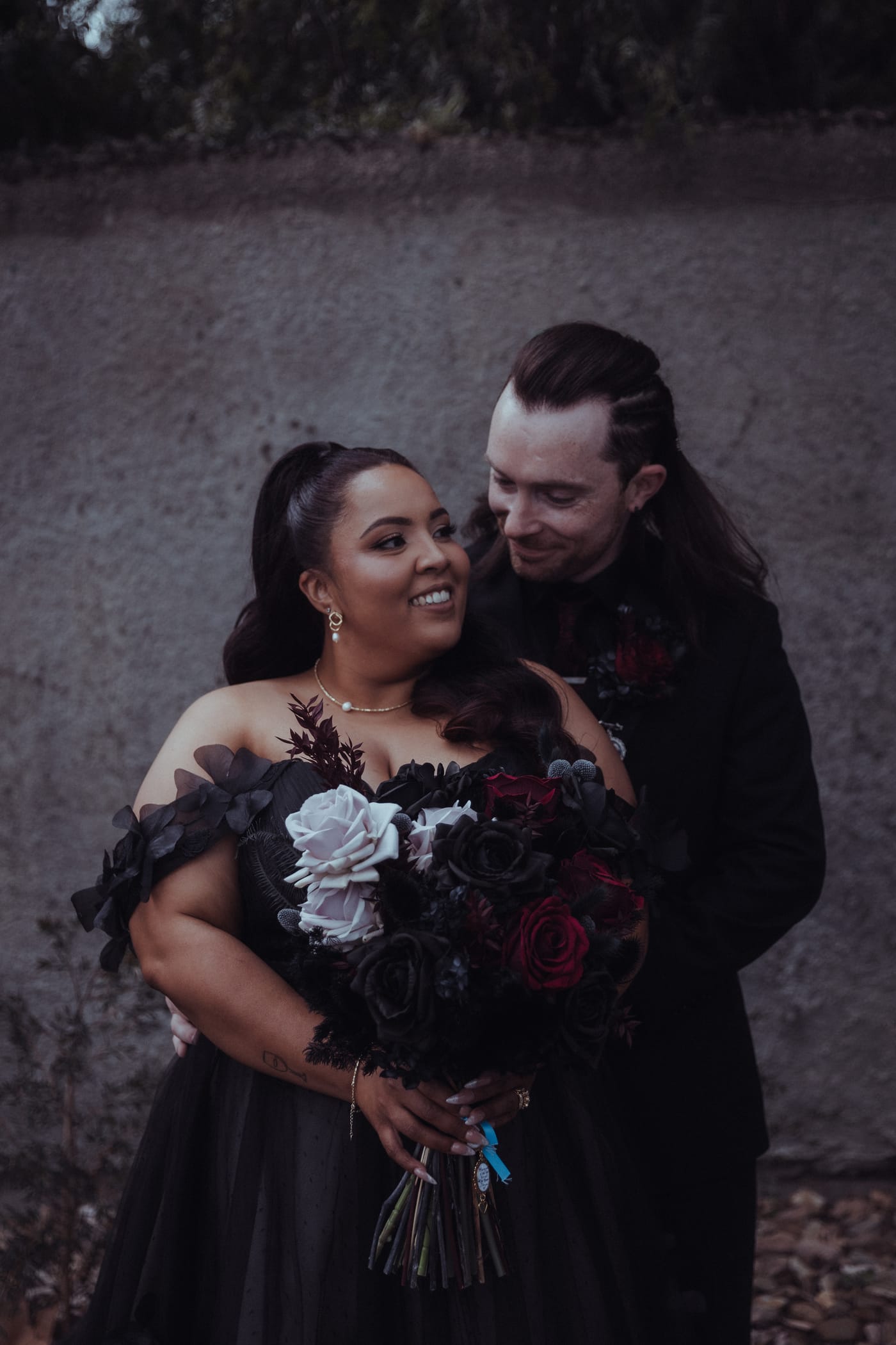 Bride holding a gothic black and red bouquet by Megan, Elder Emo Weddings